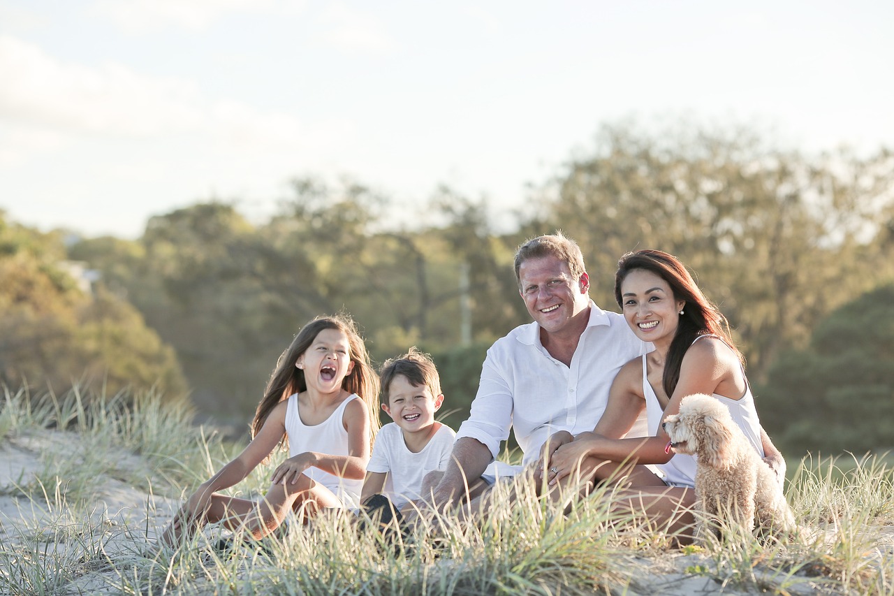 Picture of a small family sitting in a field